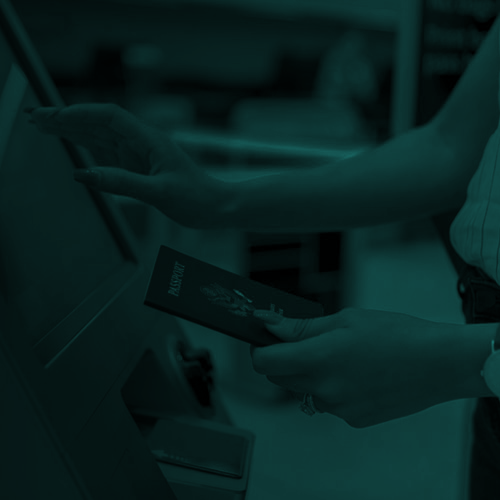 Woman holding passport using self-service airport kiosks in duotone